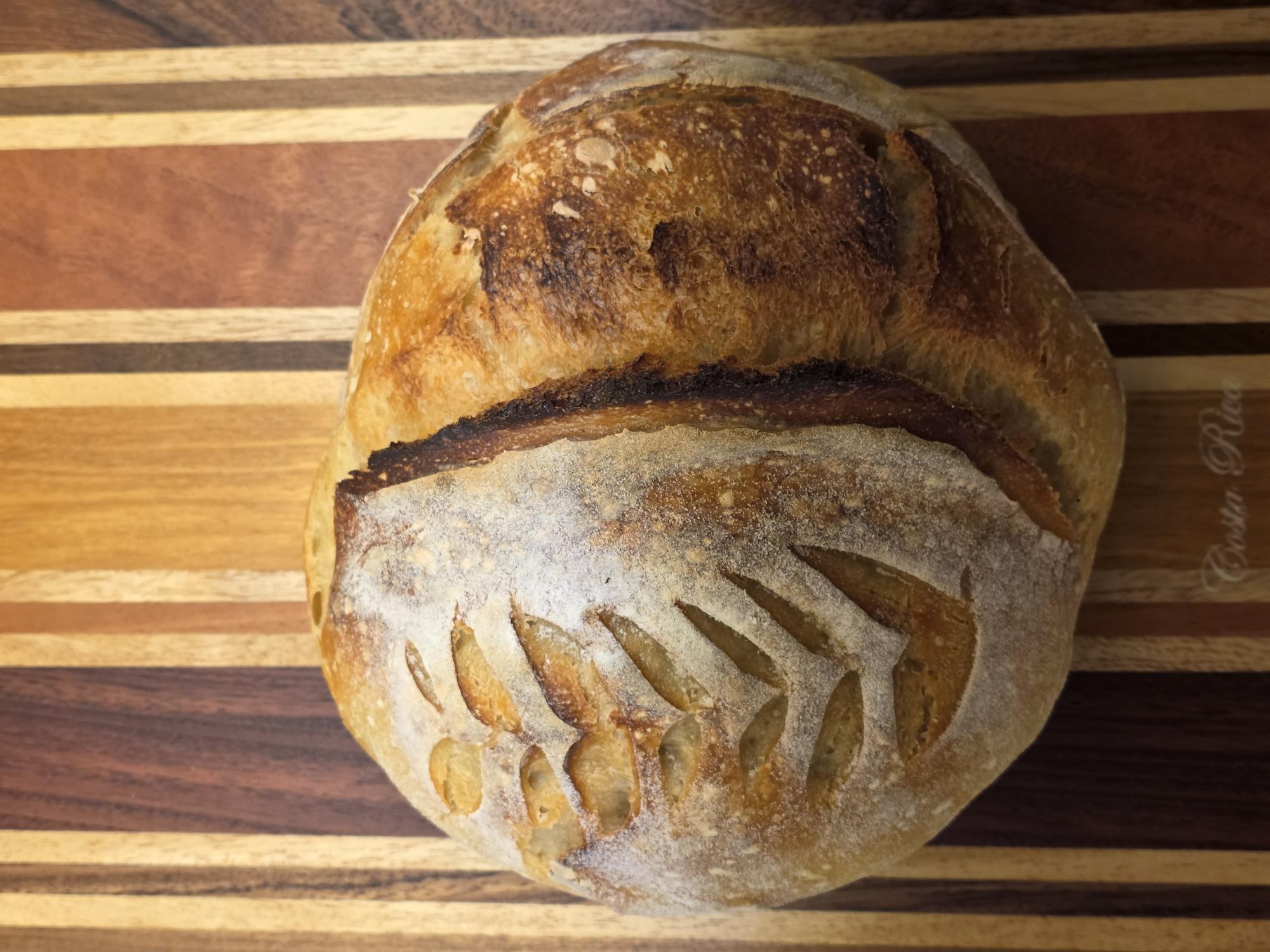 Freshly baked artisan bread on a wooden cutting board